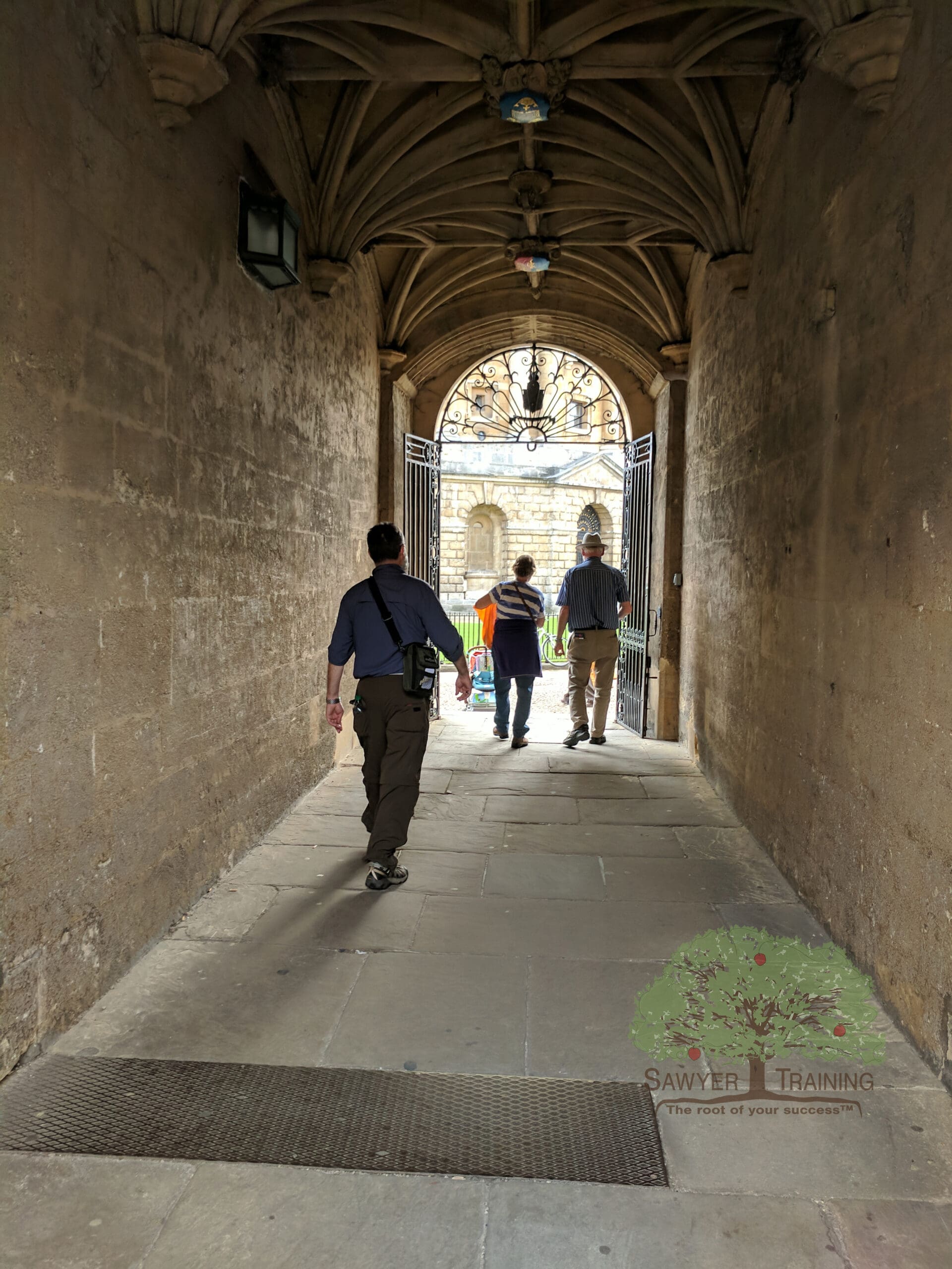 George Sawyer walking through stone walkway at Oxford